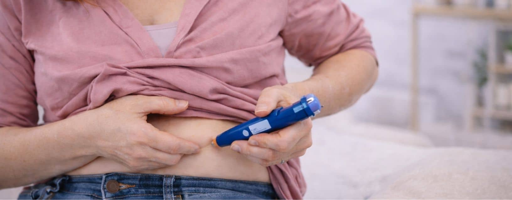 Mulher a aplicar uma injeção subcutânea na zona abdominal